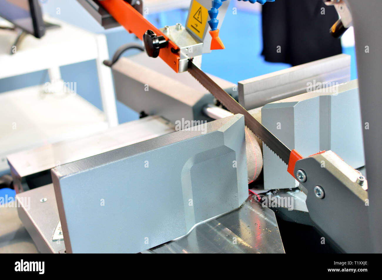 Industrial CNC lathe with band saw for cutting metal products. Coolant