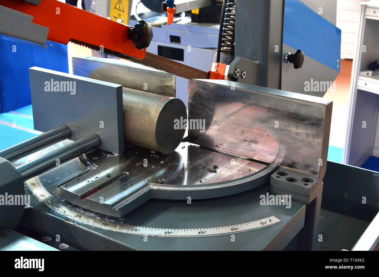 Industrial CNC lathe with band saw for cutting metal products. Coolant