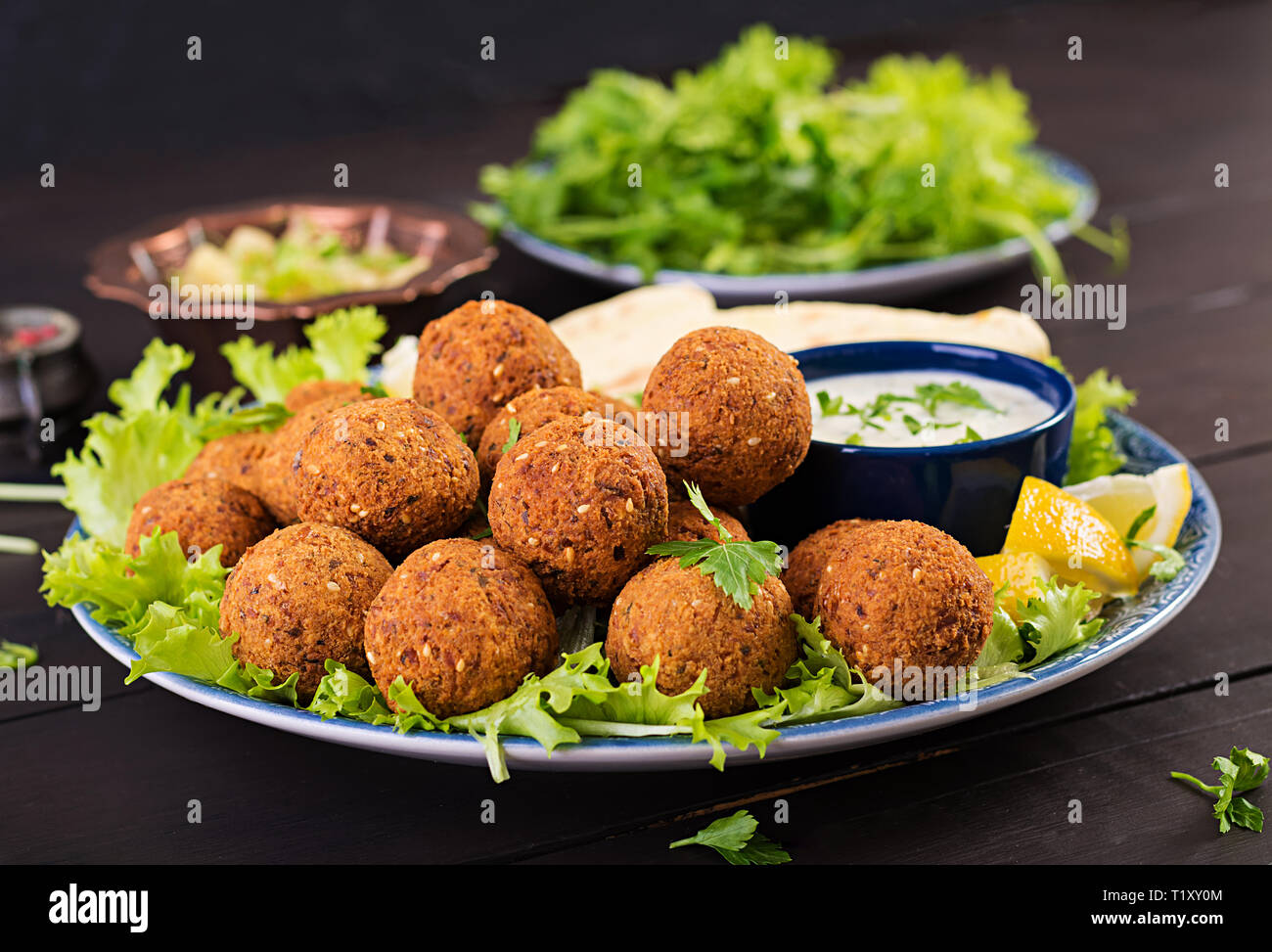 Falafel, hummus and pita. Middle eastern or arabic dishes on a dark