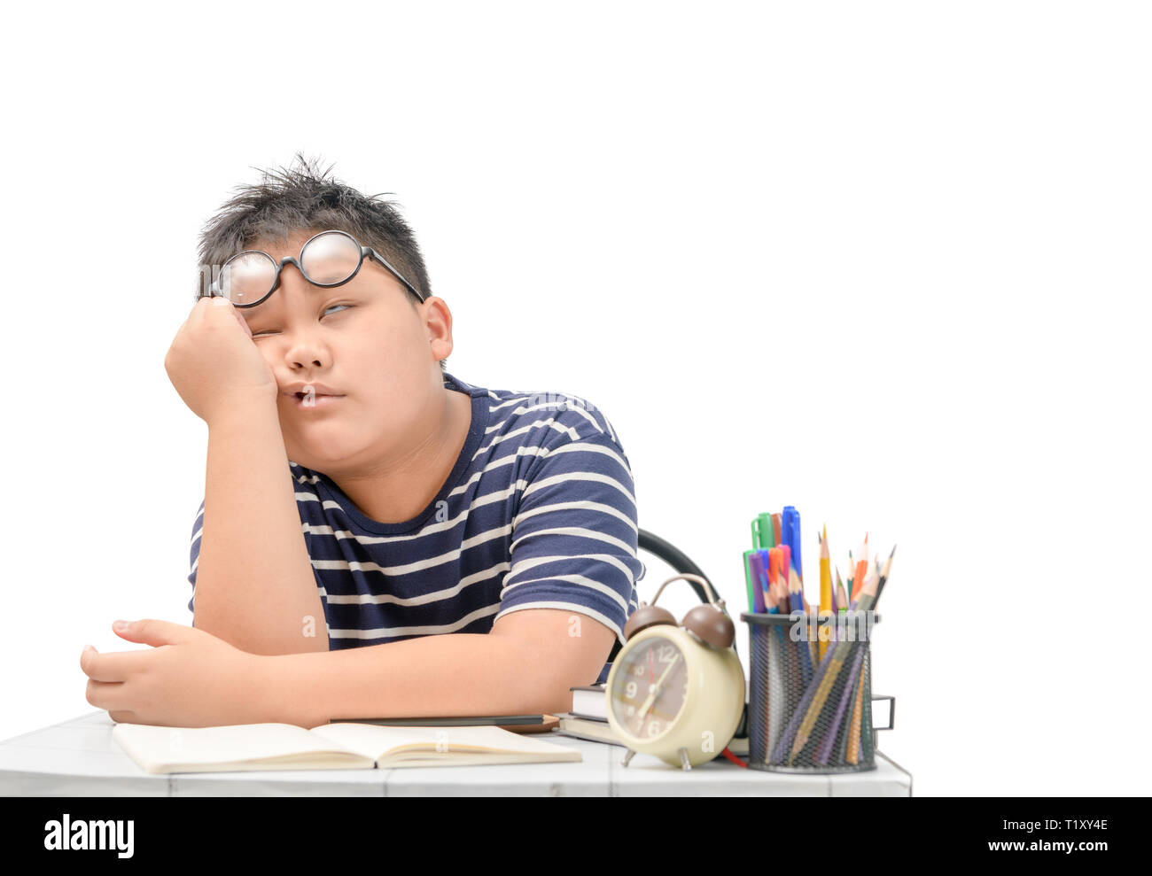 Bored and tired asian student doing homework isolated on white ...