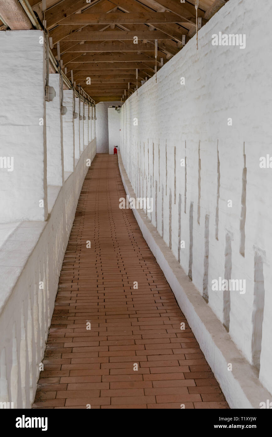 Long narrow corridor in an old building Stock Photo