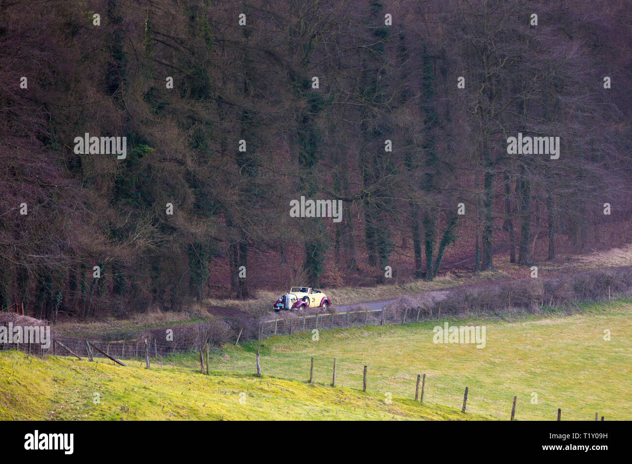 Old classic 1936 Buick 40c open top vintageant convertible car driving through country lanes in the Cotswolds, Oxfordshire. UK Stock Photo