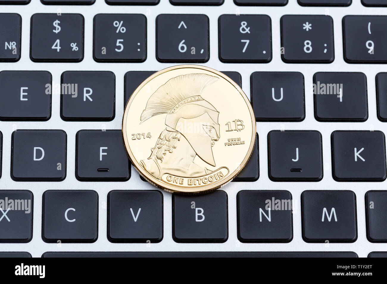 Cryptocurrency physical titan bitcoin coin on black computer keyboard. Stock Photo