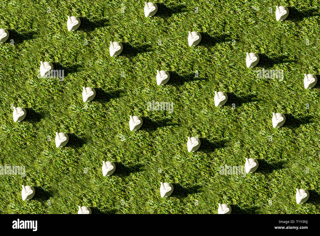 top view of decorative white rabbits on green grass surface Stock Photo ...