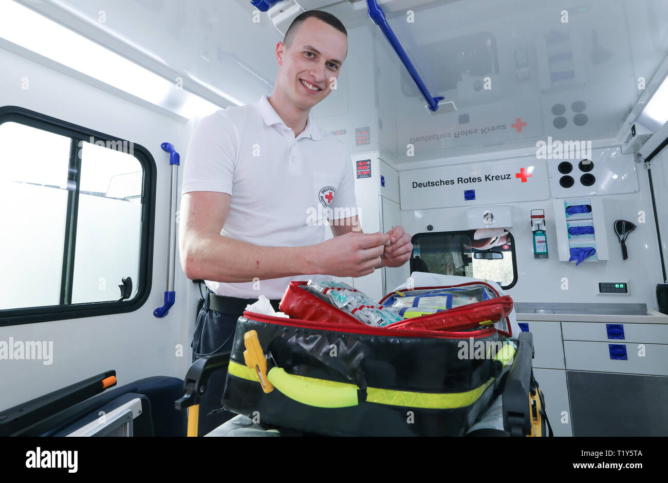 Biberach, Germany. 22nd Mar, 2019. Emergency paramedic Adrian Filser checks  medication in an emergency backpack in an ambulance (staged scene).  Emergency paramedics are in a constant balancing act between bodily injury  and