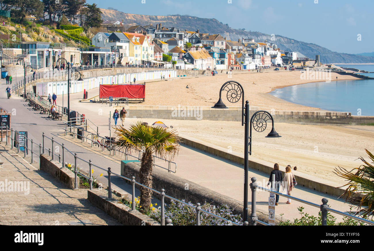 Lyme Regis, Dorset, UK. 29th March 2019. UK Weather: Another day of glorious sunshine and bright blue skies as the seaside resort town of Lyme Regis as the early spring heatwave continues.  Visitors and families enjoy the unseasonably hot weather on the sandy beach. Credit: Celia McMahon/Alamy Live News Stock Photo
