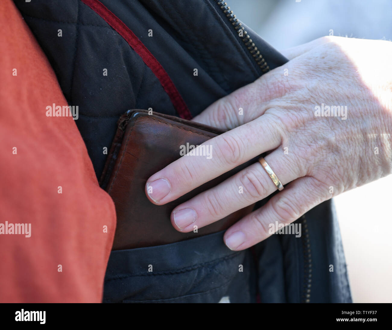 Wiesbaden, Germany. 29th Mar, 2019. The hand of Uwe Mettlach of the Police Academy Hesse pulls the purse of a passer-by in the Wiesbaden pedestrian zone unnoticed from the inside pocket of the jacket during the police security day. The police in Hesse want to fight street crime and work with the tricks of thieves. Actions and information stands are designed to improve citizens' sense of security. Credit: Arne Dedert/dpa/Alamy Live News Stock Photo