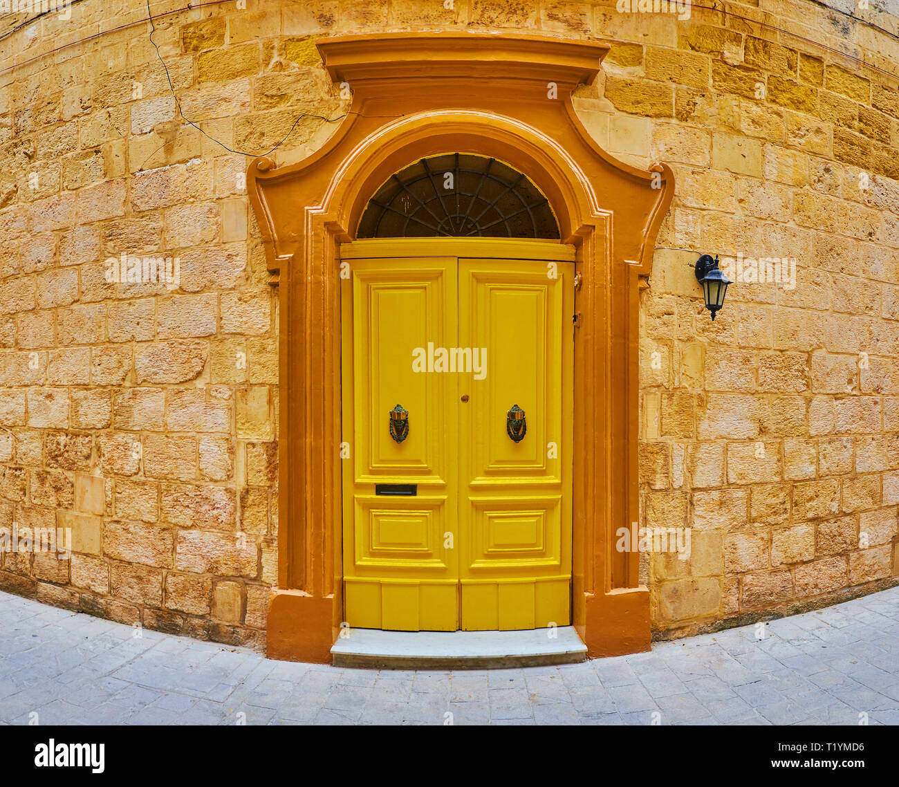 The living mansion boasts massive bright yellow wooden door with