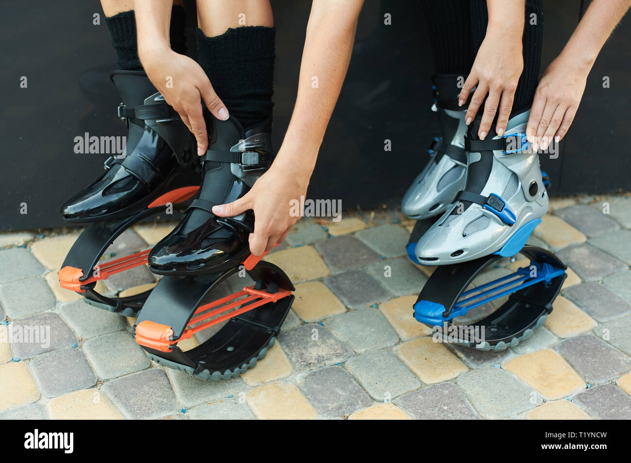 two women put on kangoo jumps boots before workout. Closeup shot with hands  Stock Photo - Alamy