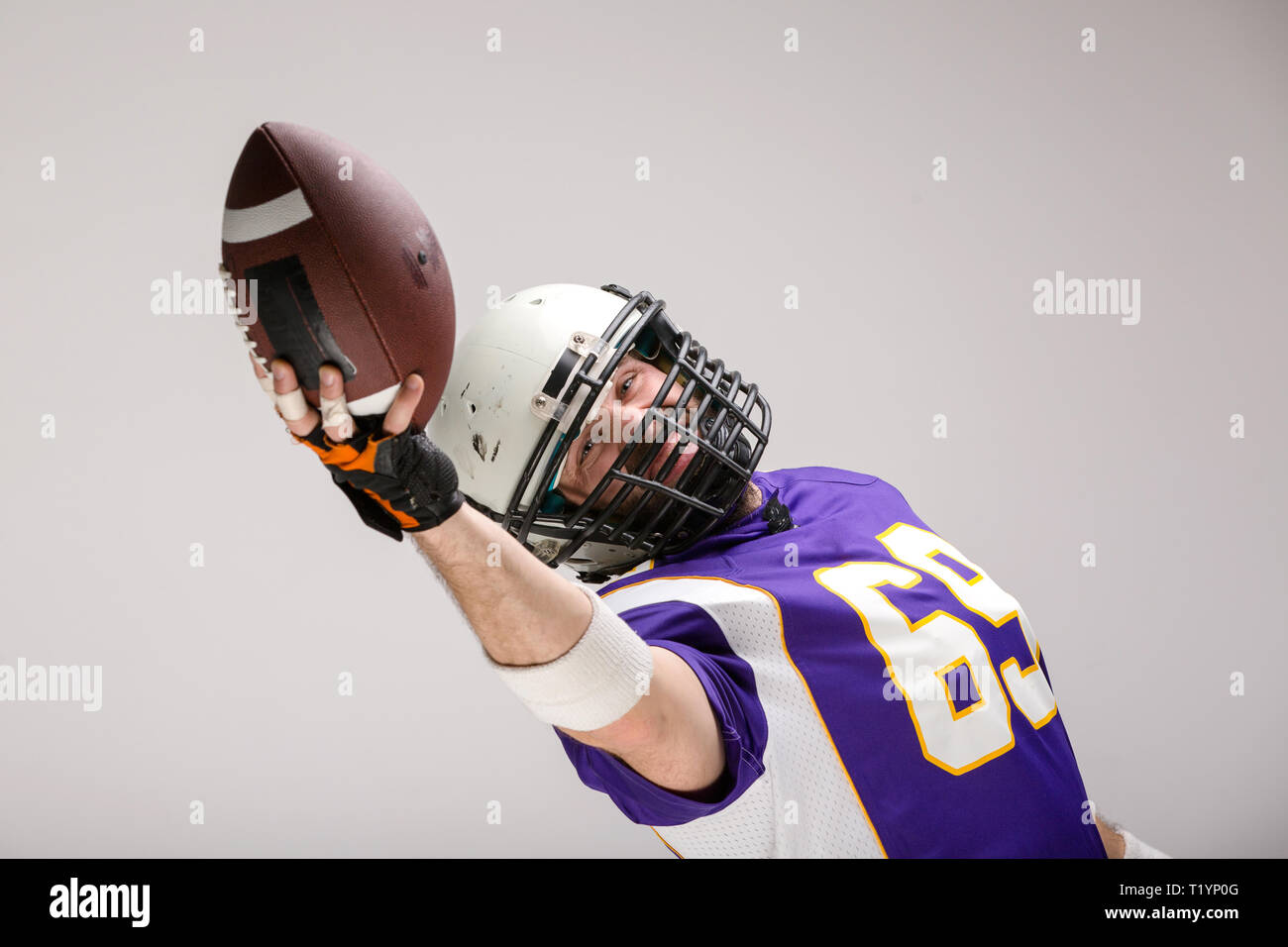Bearded American football player in helmet, portrait Stock Photo - Alamy