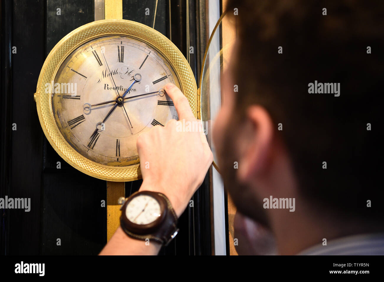 horologist james harris winds a mechanical clock made by matthias hipp late 19th century at the clockworks museum in west norwood london where they have the task of putting their collection of clocks forward an hour ahead of this weekends daylight saving time T1YR5N