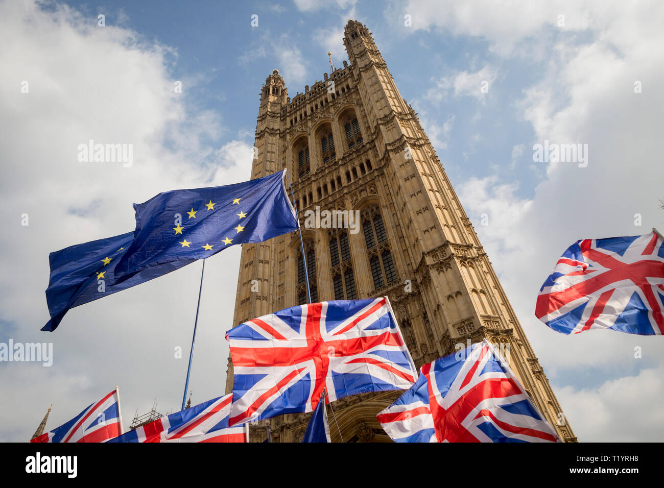 As MPs decide on how to progress with Brexit parliamentary procedure, EU and Union Jack flags fly outside the UK Parliament in Westminster, on 28th March 2019, in London, England Stock Photo