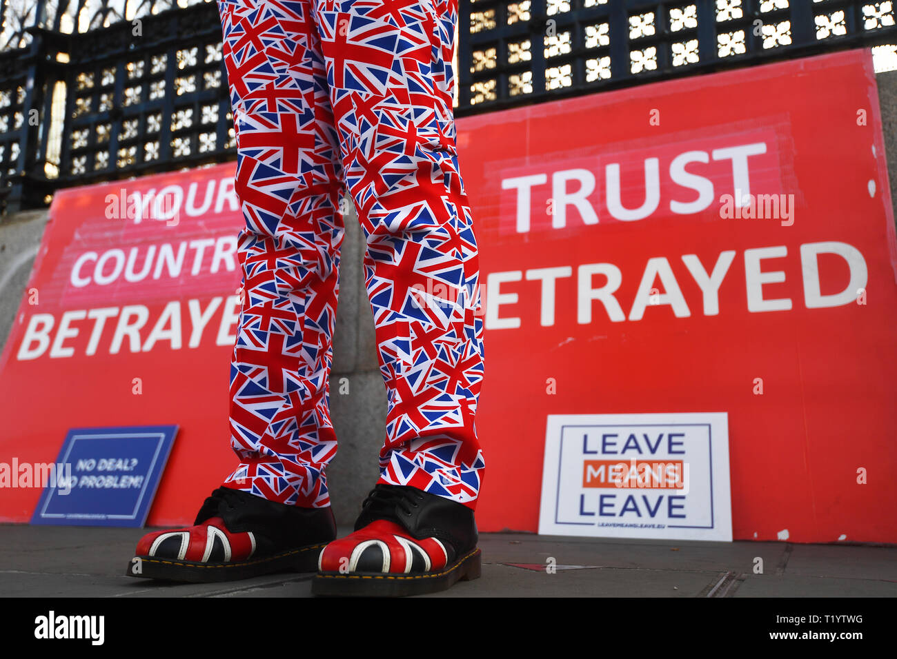 A leave protestor wearing Union flag trousers outside Westminster, London, as MPs are expected to consider and vote on a Government motion on the EU withdrawal on Friday evening. Stock Photo