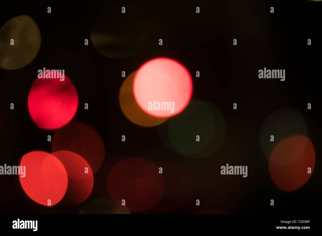 Abstract multicolored bokeh balls floating across a dark background Stock Photo