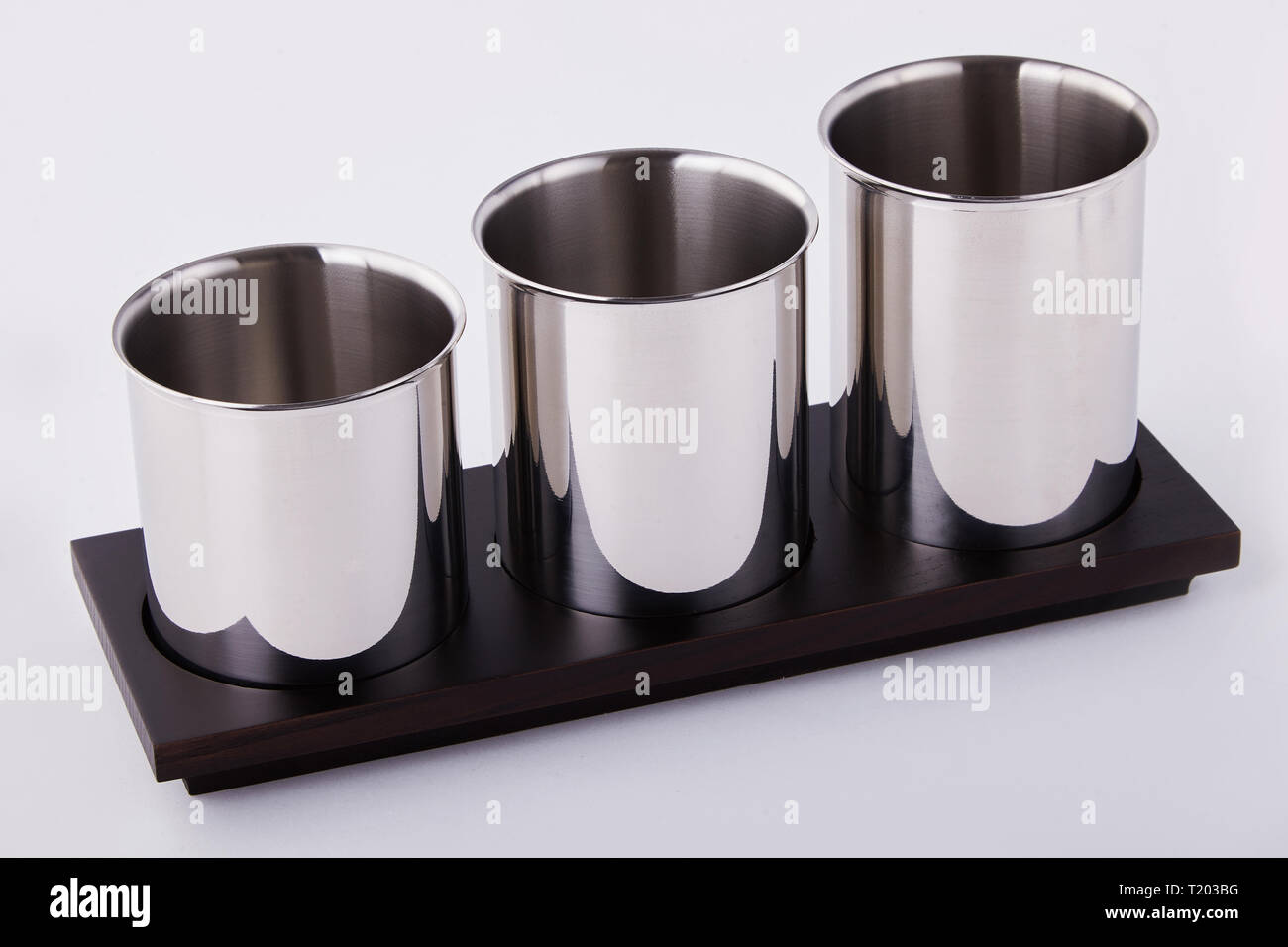 Metal cutlery stand. Spoon, forks and straws Stand on a white