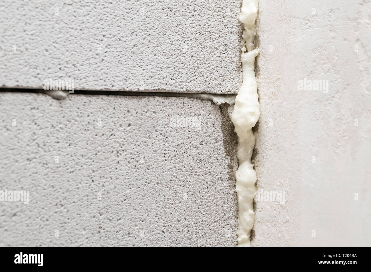 foamfilled joint between aerated concrete blocks, closeup Stock Photo