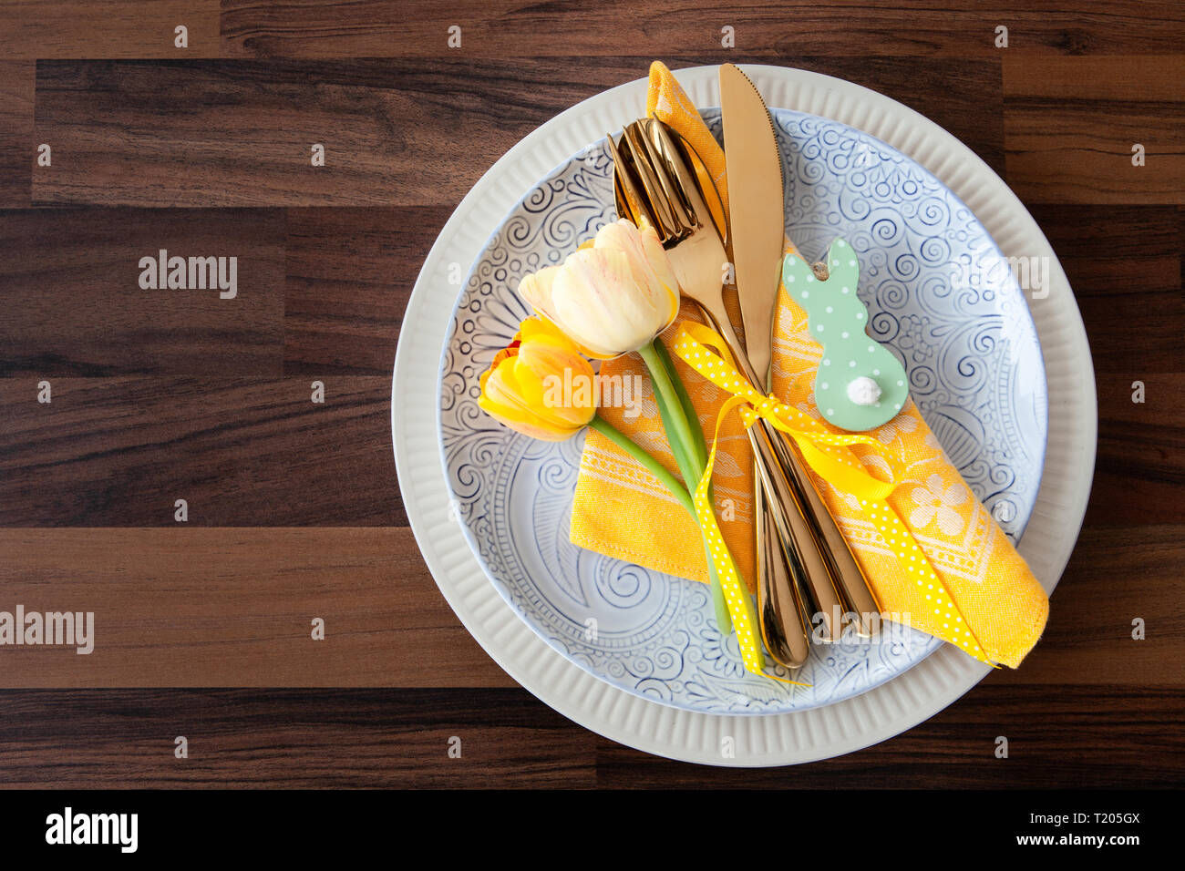 Festive table setting with fresh tulips for easter Stock Photo