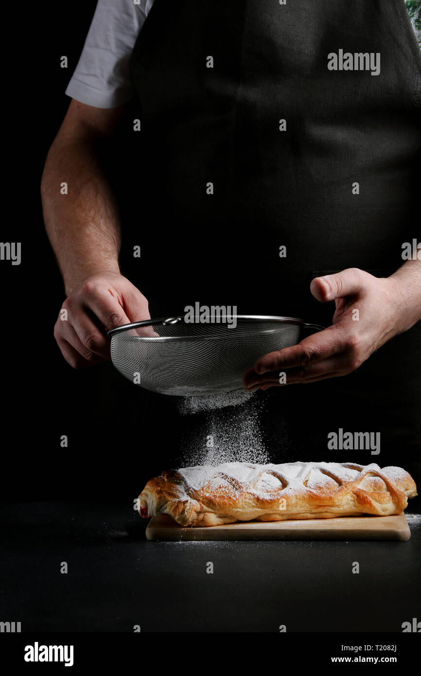 baker decorating on dark background. recipe concept. Stock Photo