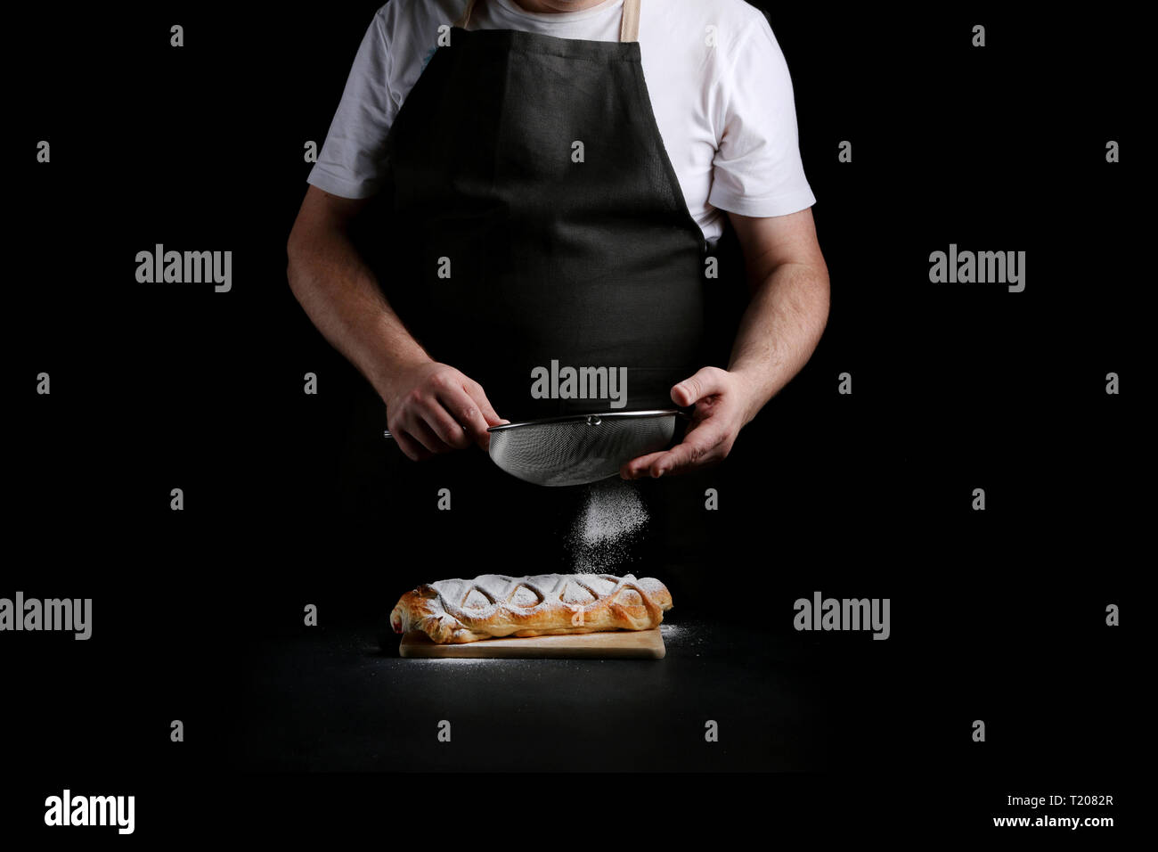 baker decorating on dark background. recipe concept. Stock Photo