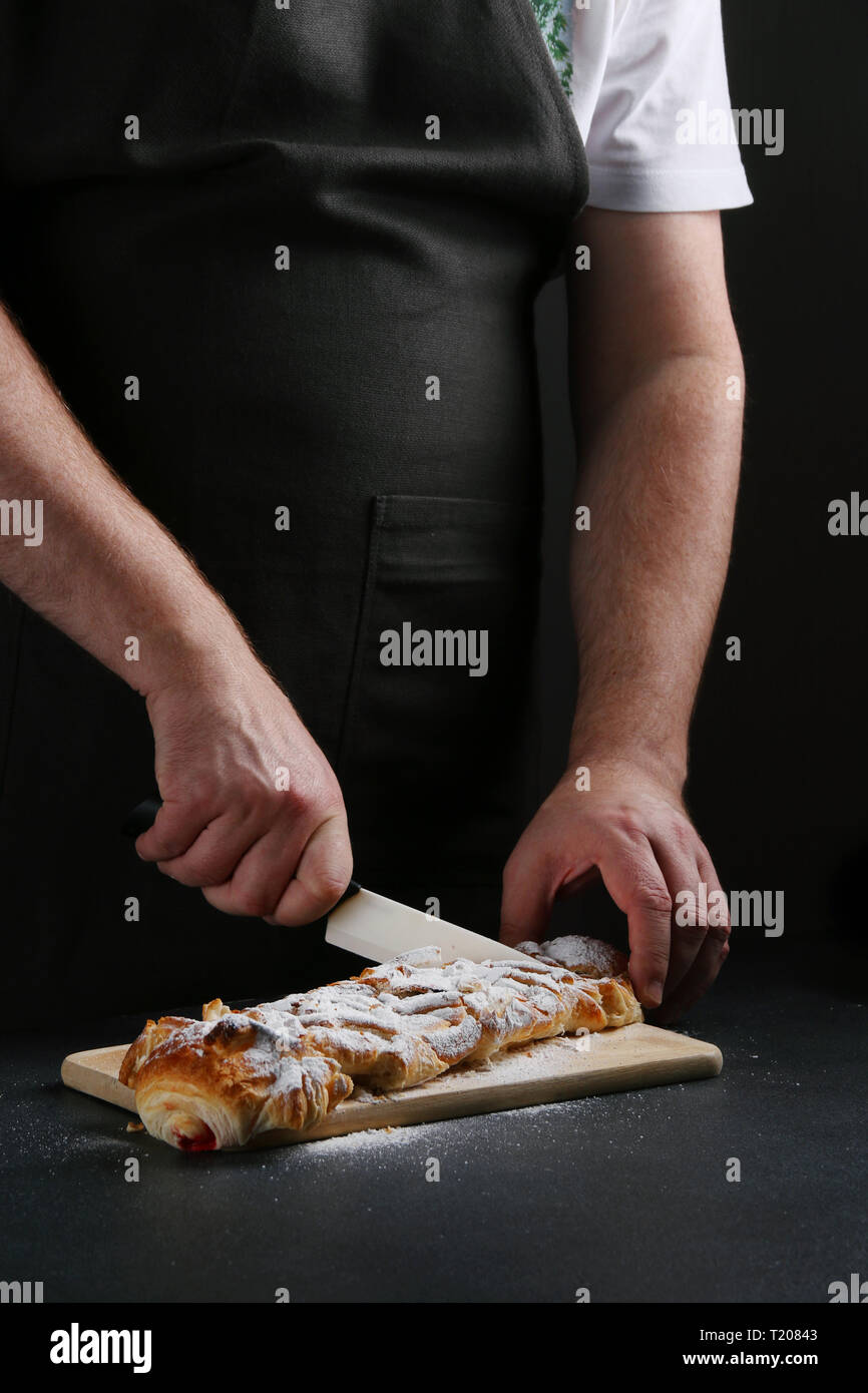 baker decorating on dark background. recipe concept. Stock Photo