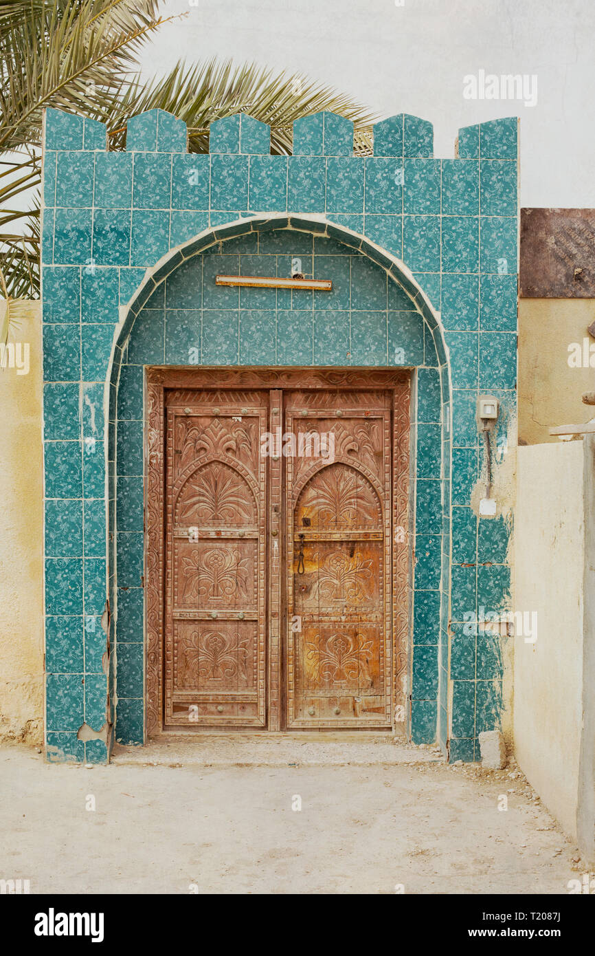 Front of a house in a village in Oman. Decorated with colorful glazed tiles. Stock Photo