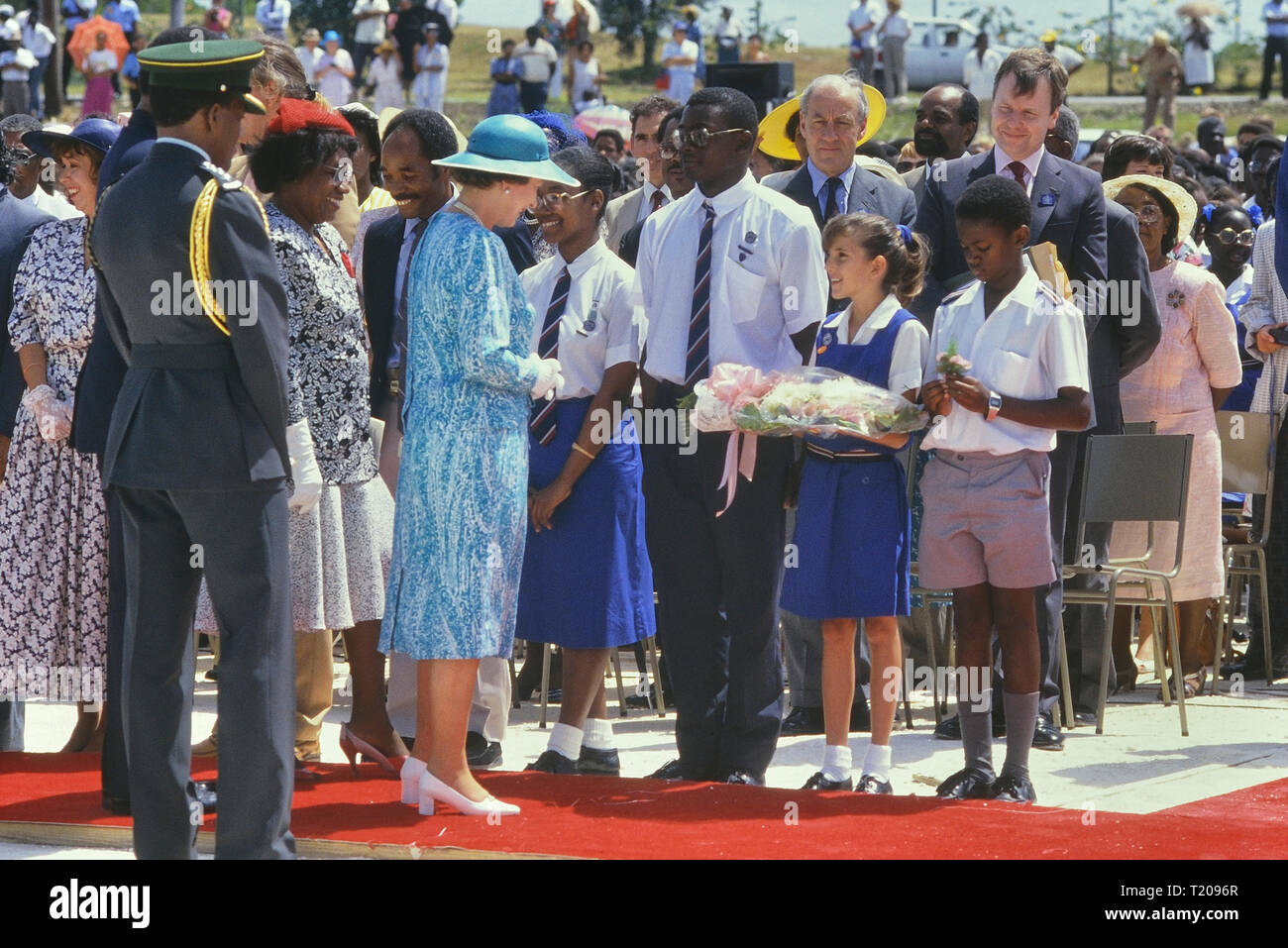 Queen Elizabeth II visit to Queen's College to officiate at a stone laying ceremony for the new school building. Barbados, Caribbean. 1989 Stock Photo