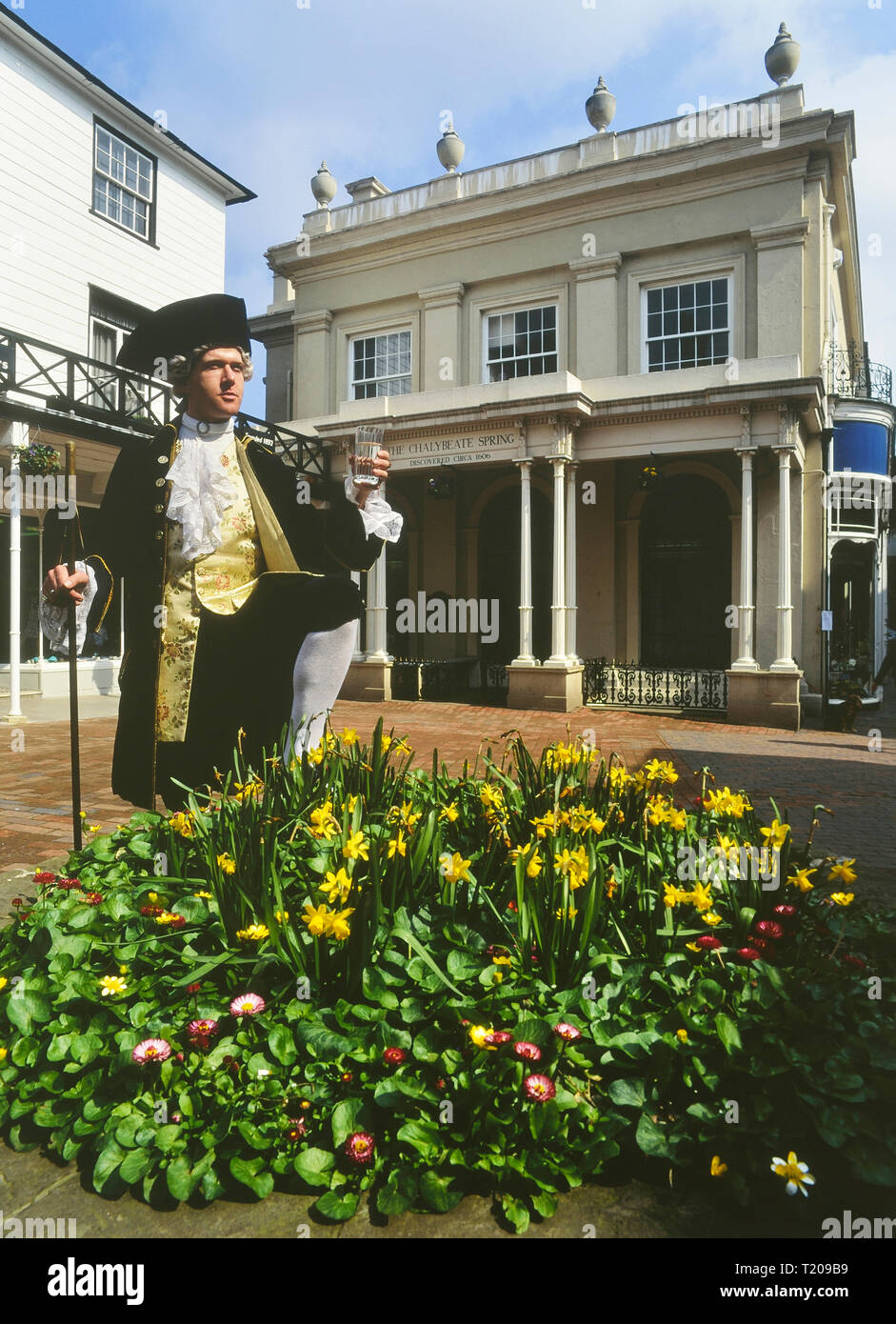 A uniformed dipper poses with a glass of water at he Chalybeate Spring