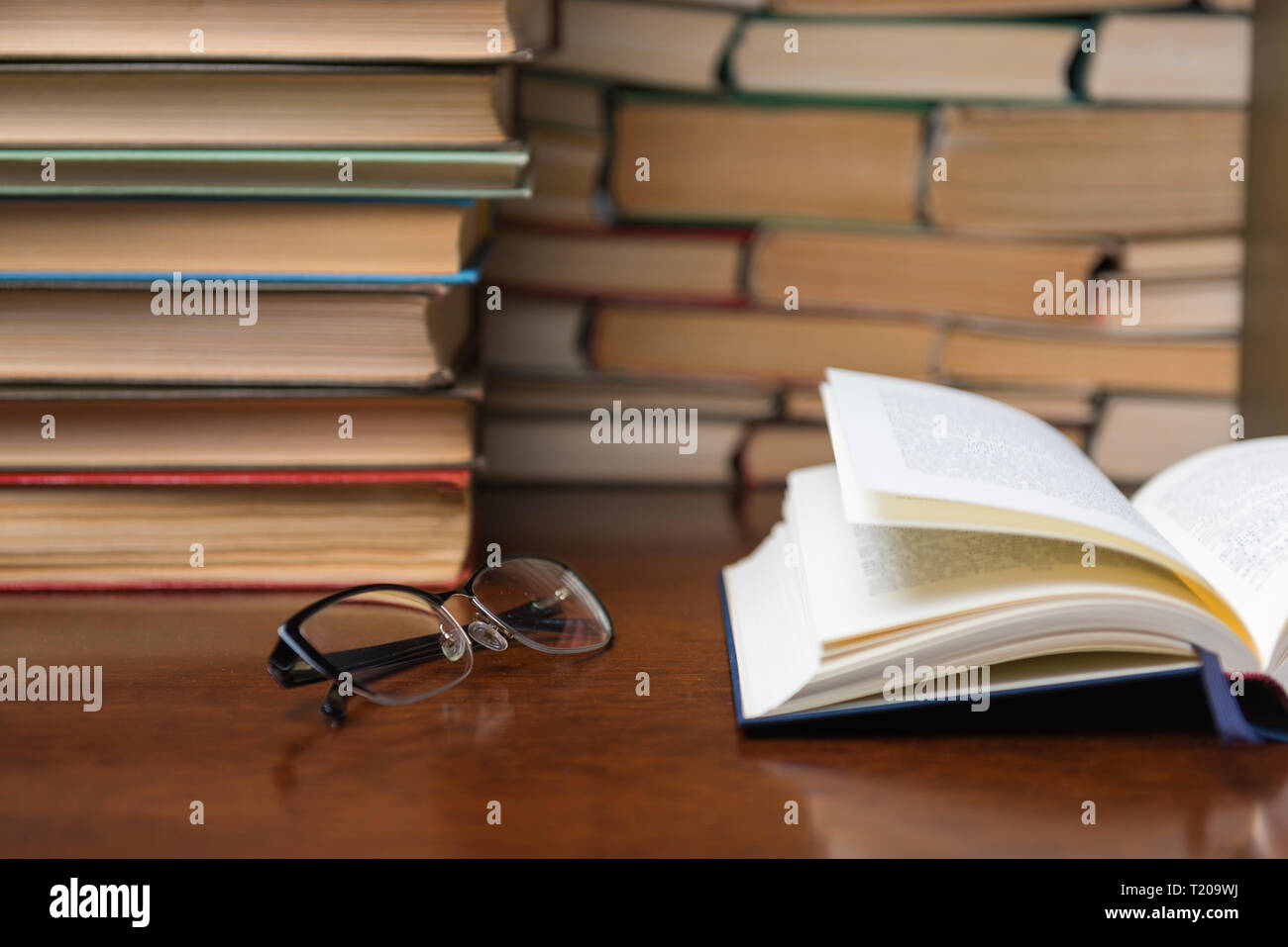 Book Behind Table open book on the table against the background of books Stock Photo - Alamy