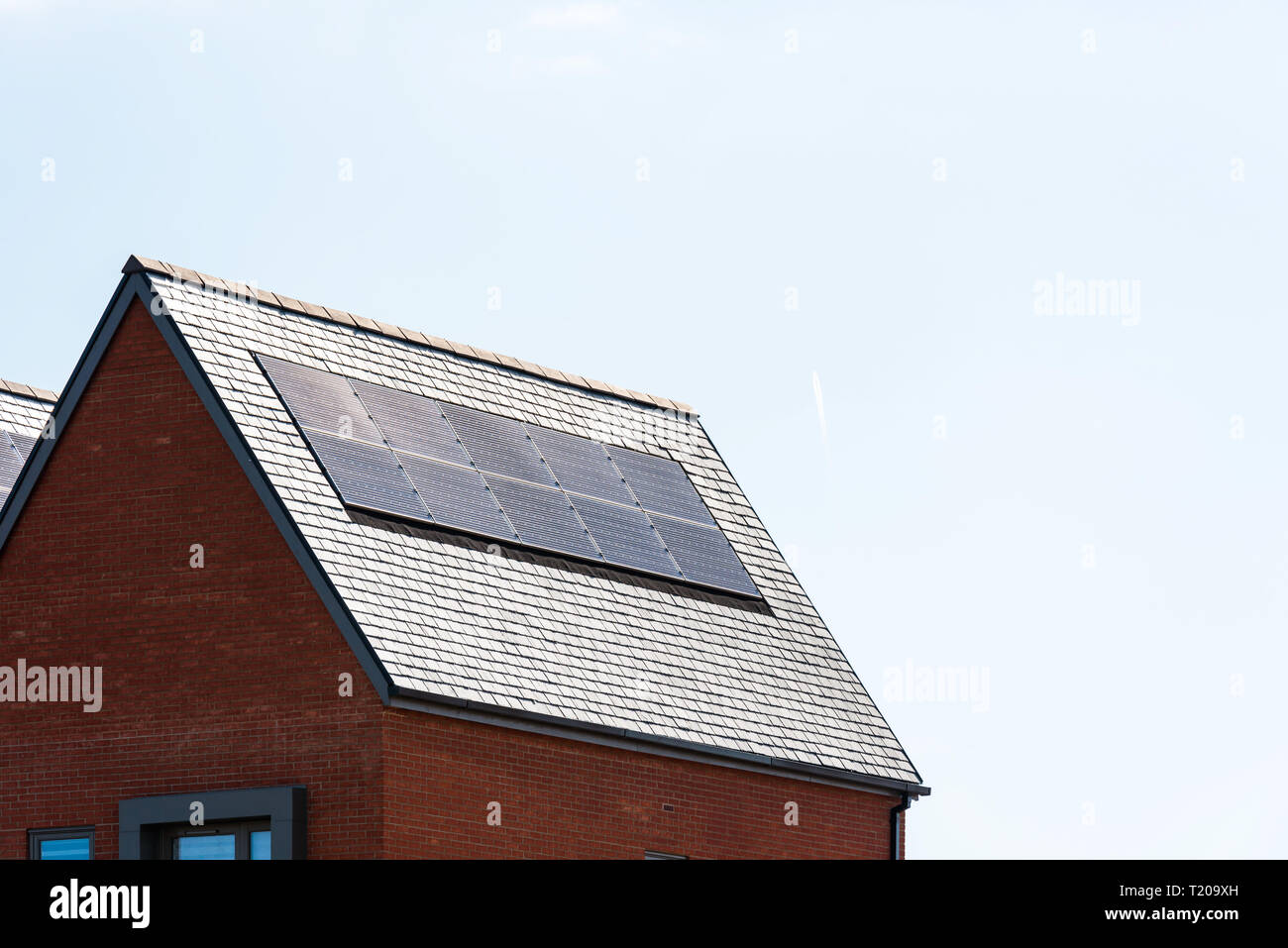 solar panels on roof of new houses in england uk on bright sunny day