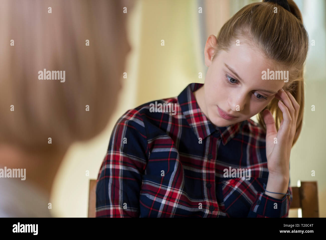 Depressed Teenage Girl Meeting With Counselor Stock Photo