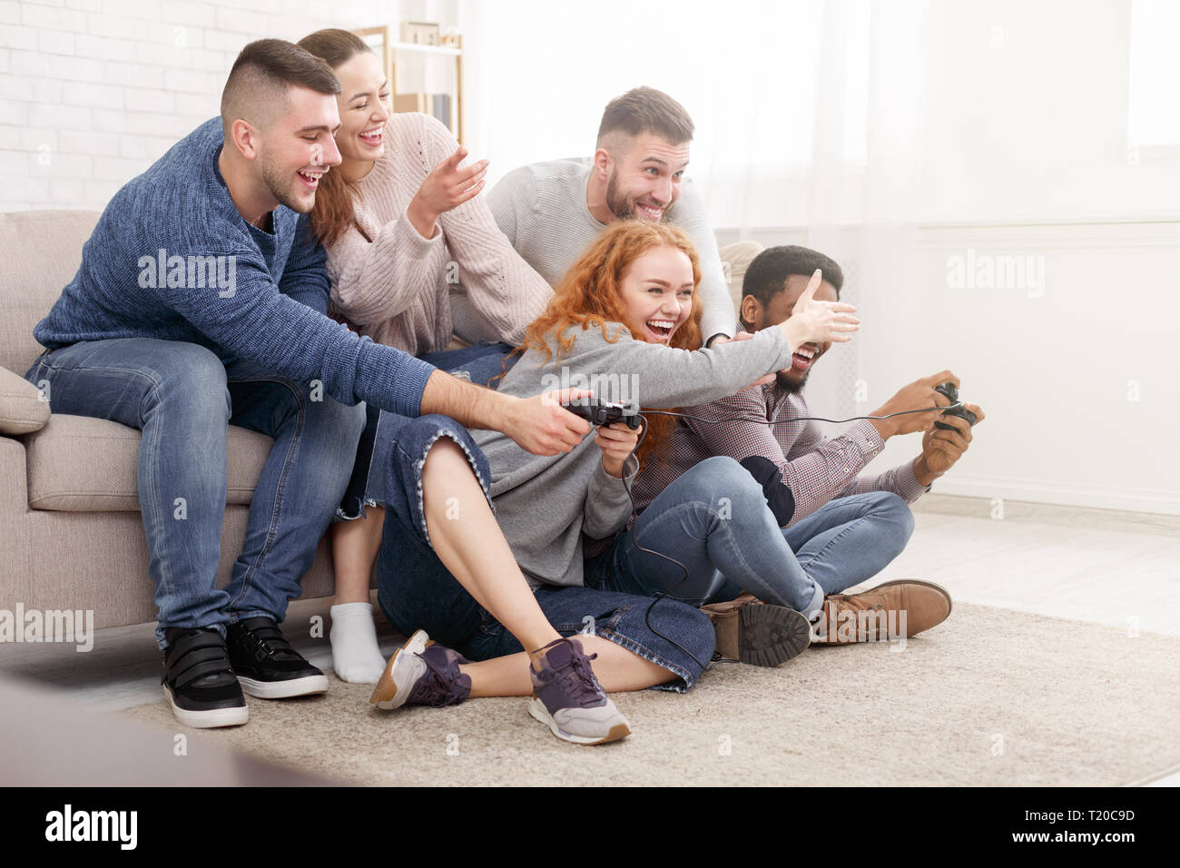 Students having fun, playing video games online Stock Photo