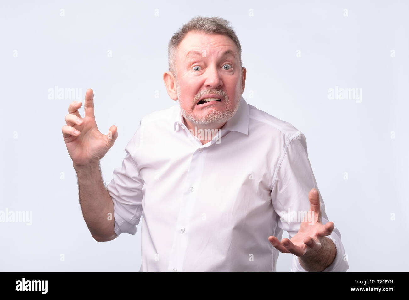 Angry senior european man who threaten you. Negative facial emotion. Stock Photo