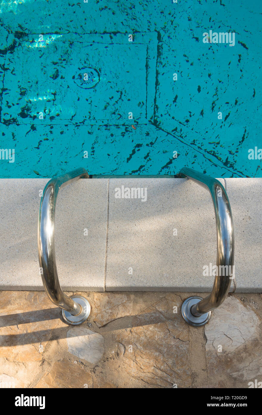Down the stairs of a dirty pool. The stairs of swimming pool. Dirty