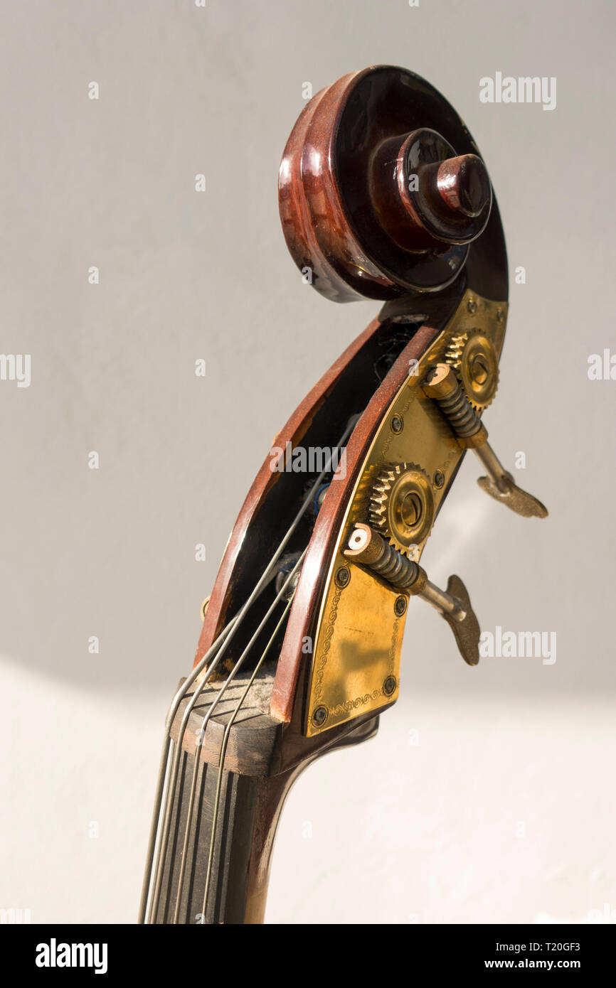 head and scroll and tuning pegs of a hand carved Double bass. Stock Photo