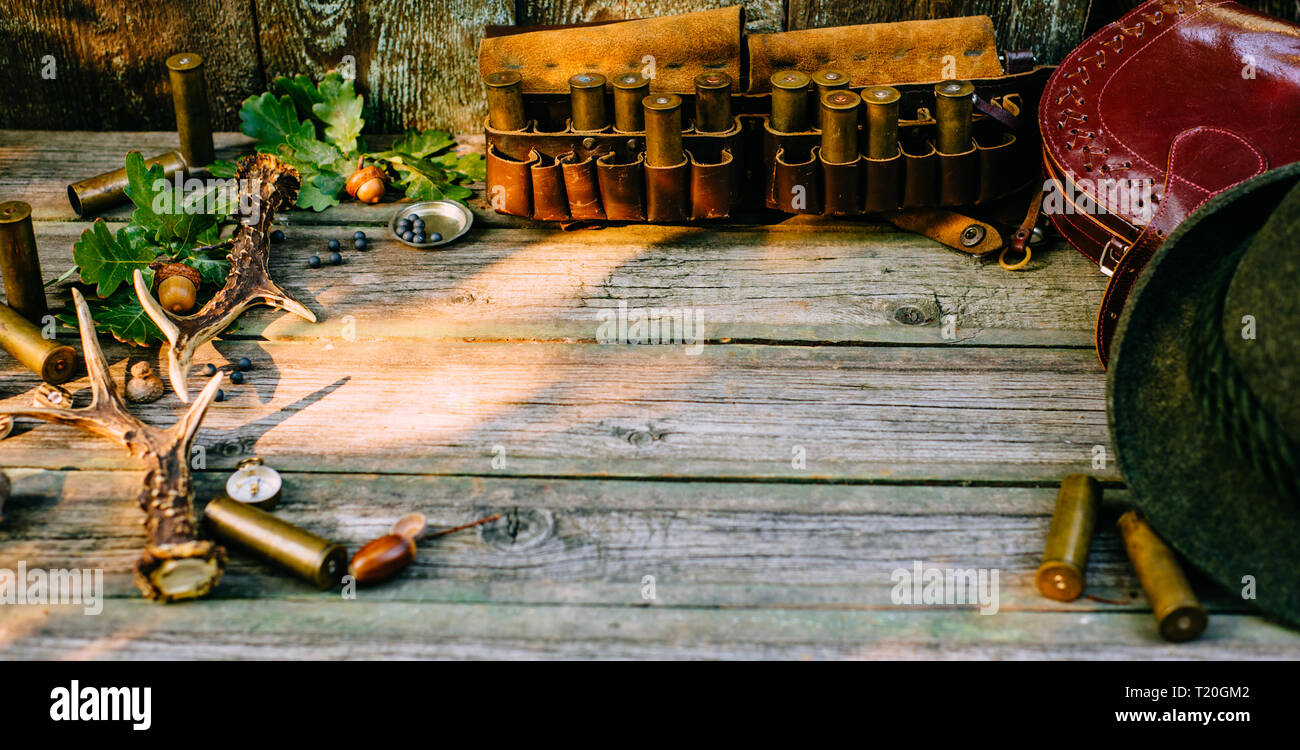 Hunting equipment, oak and horns around of old wood board Stock Photo