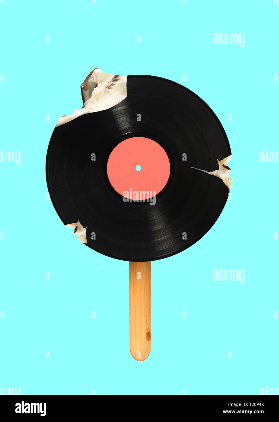 An alternative icecream. Meloman wanna bite a piece of immortal music. Vinyl record formed icecream on a wooden stick against blue sky colored background. Modern design. Contemporary art collage. Stock Photo