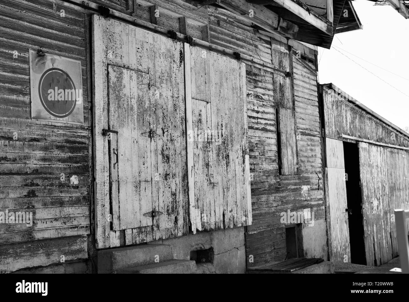 Black and white abandoned barn on the side of the in a rural town Stock Photo