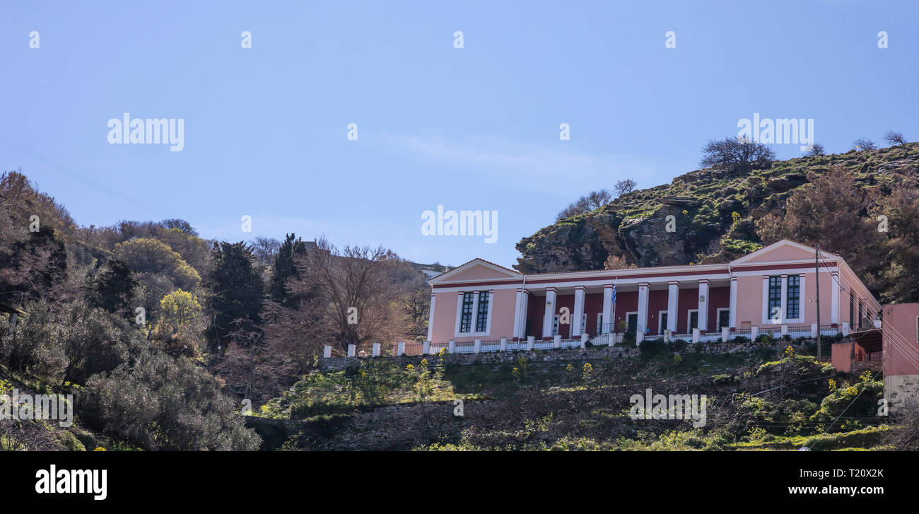 Greece, Kea island. Old public school, neoclassical building above on the hill, at Ioulida. Sunny day in spring Stock Photo