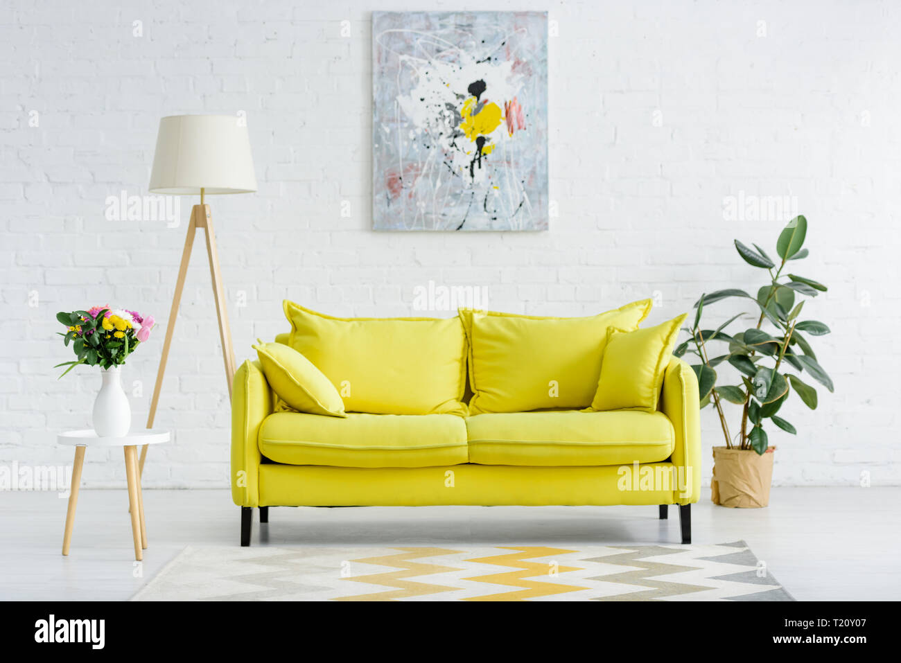 interior of modern white living room with decor and bright yellow sofa  Stock Photo - Alamy