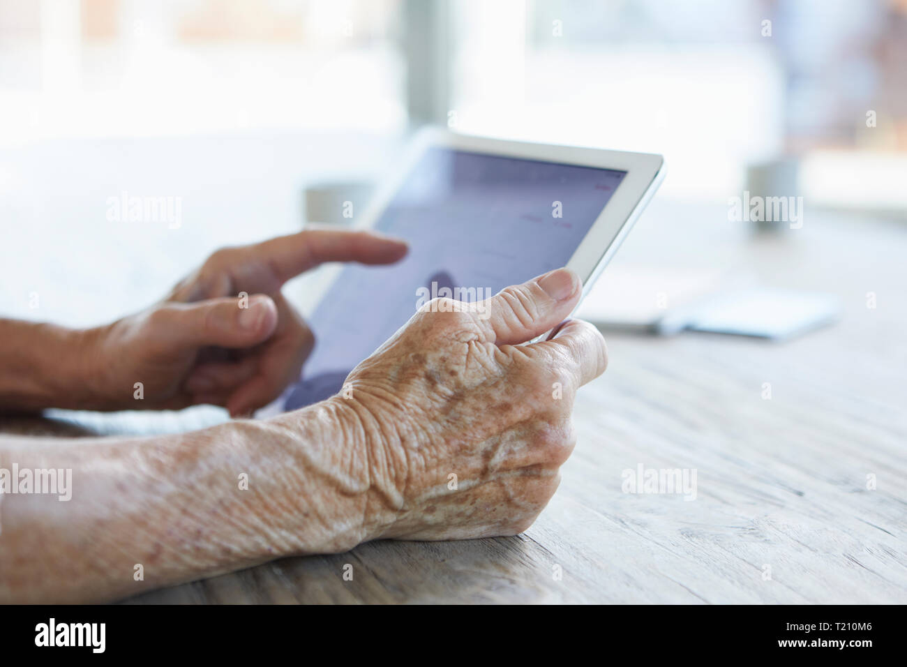 Woman's hand holding digital tablet, close-up Stock Photo
