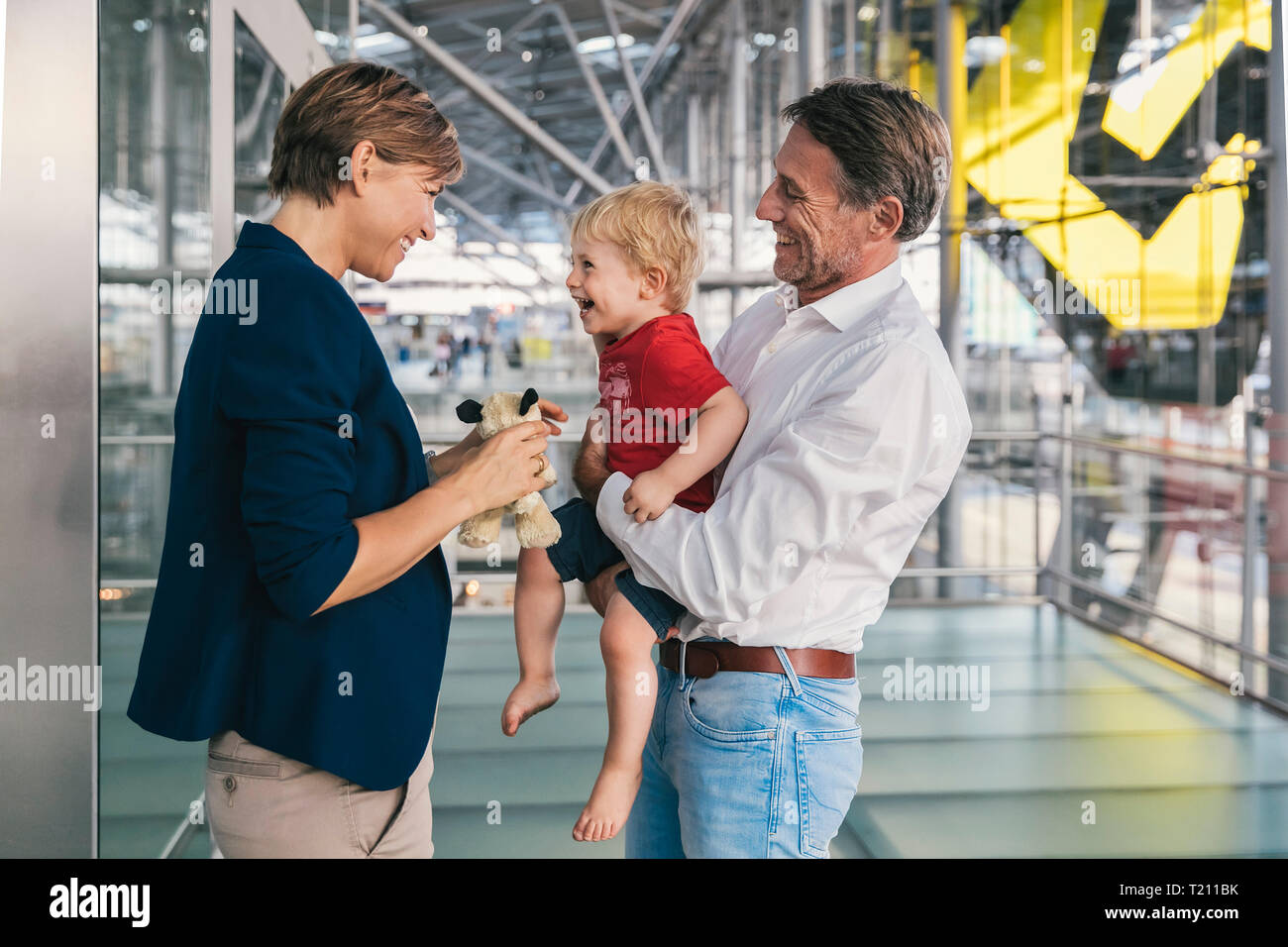Small boy being happy upon his business mother's arrival at the airport Stock Photo