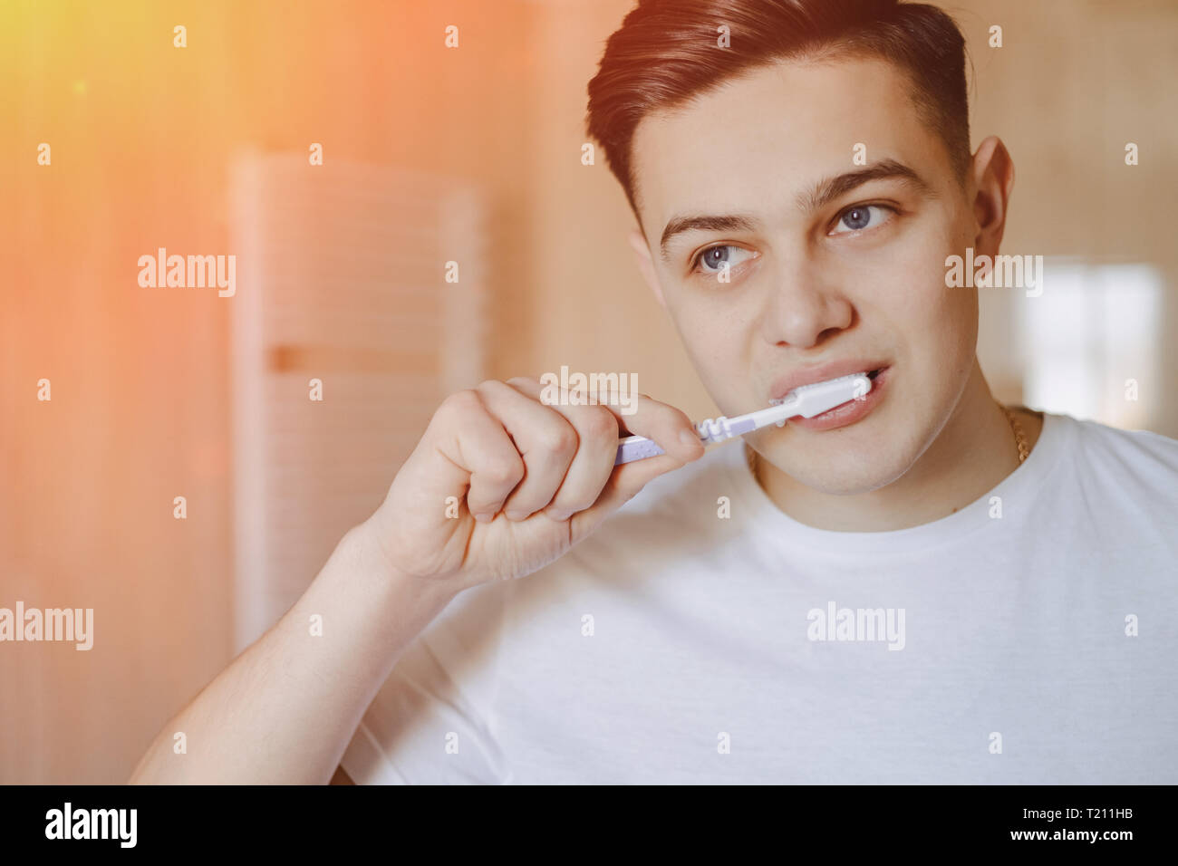Morning Hygiene The Boy Brushes His Teeth Near The Mirror In The Bright Bathroom Stock Photo Alamy
