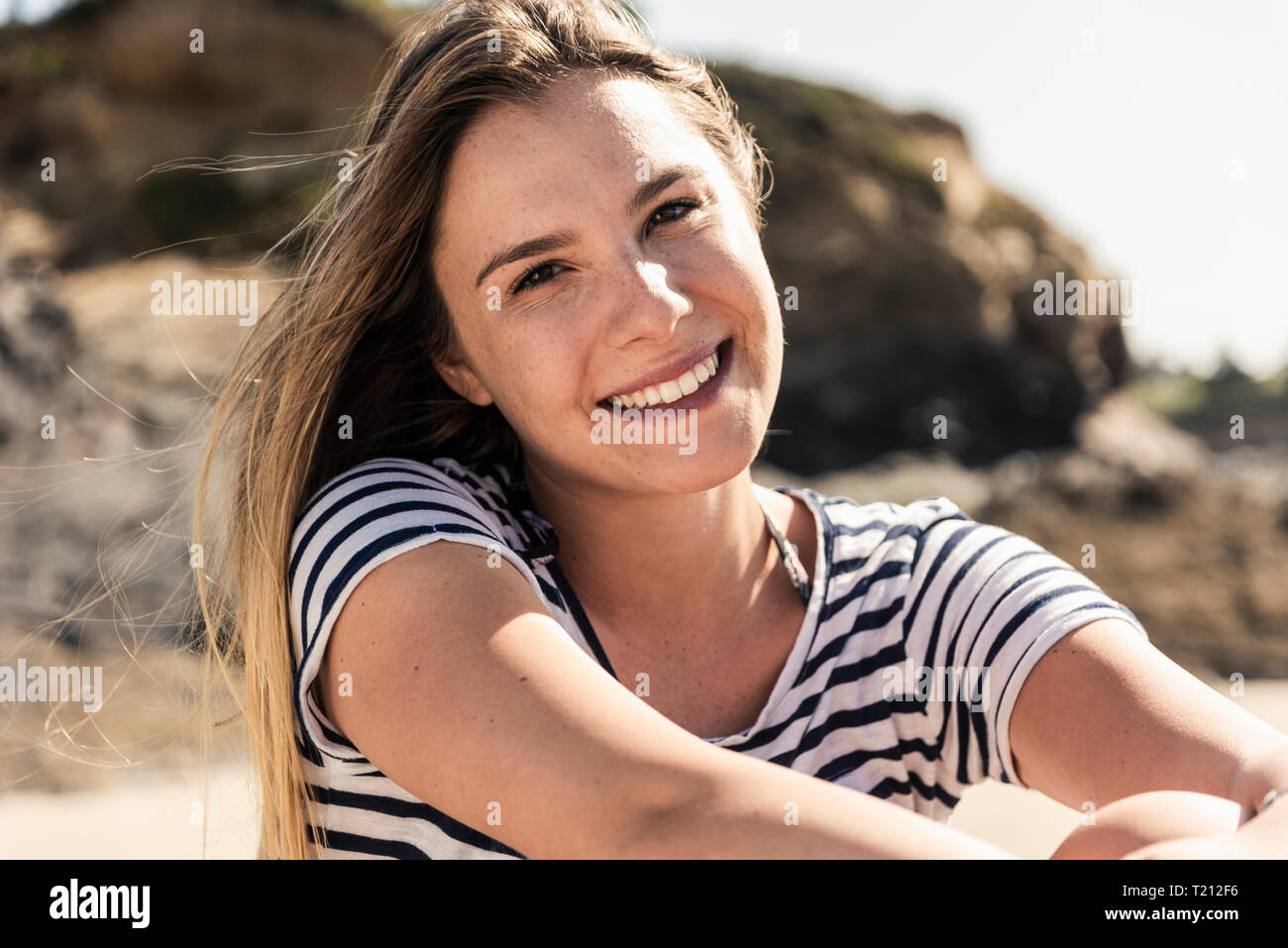 Portrait of a happy young woman on the beach Stock Photo - Alamy