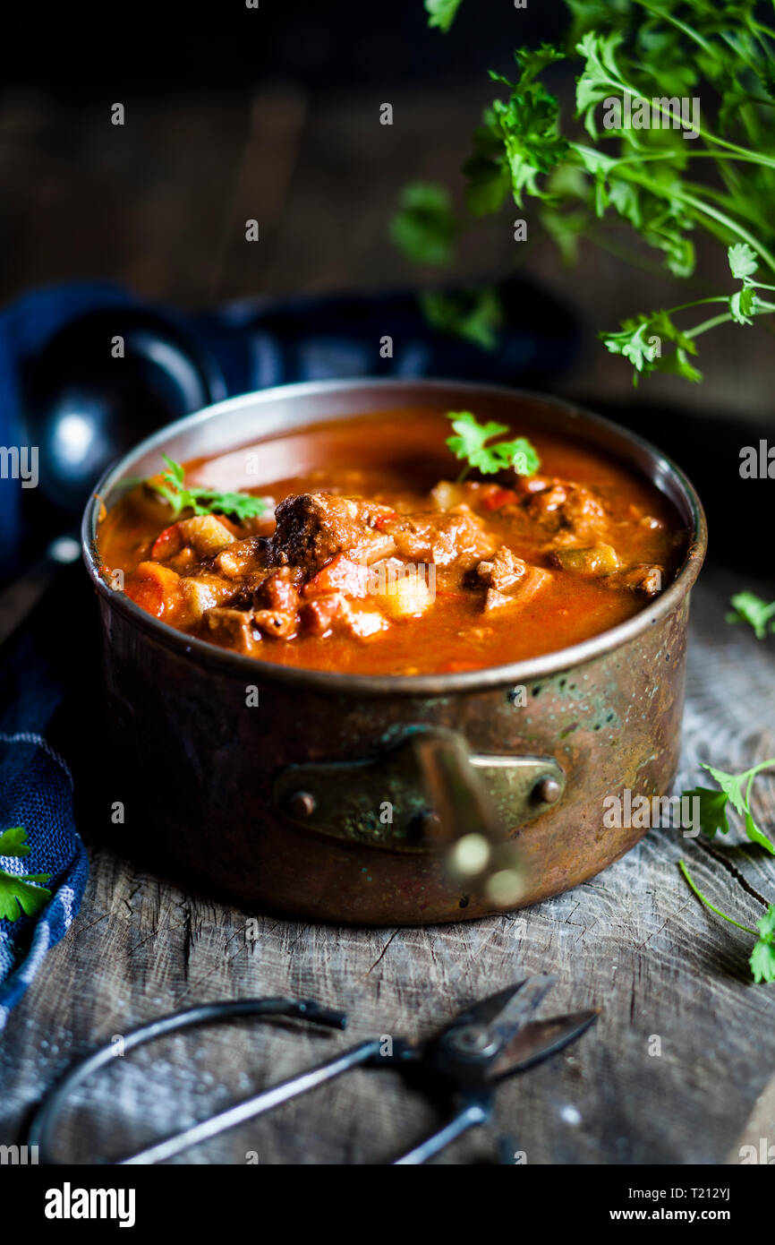 Goulash soup with flat leaf parsley Stock Photo Alamy