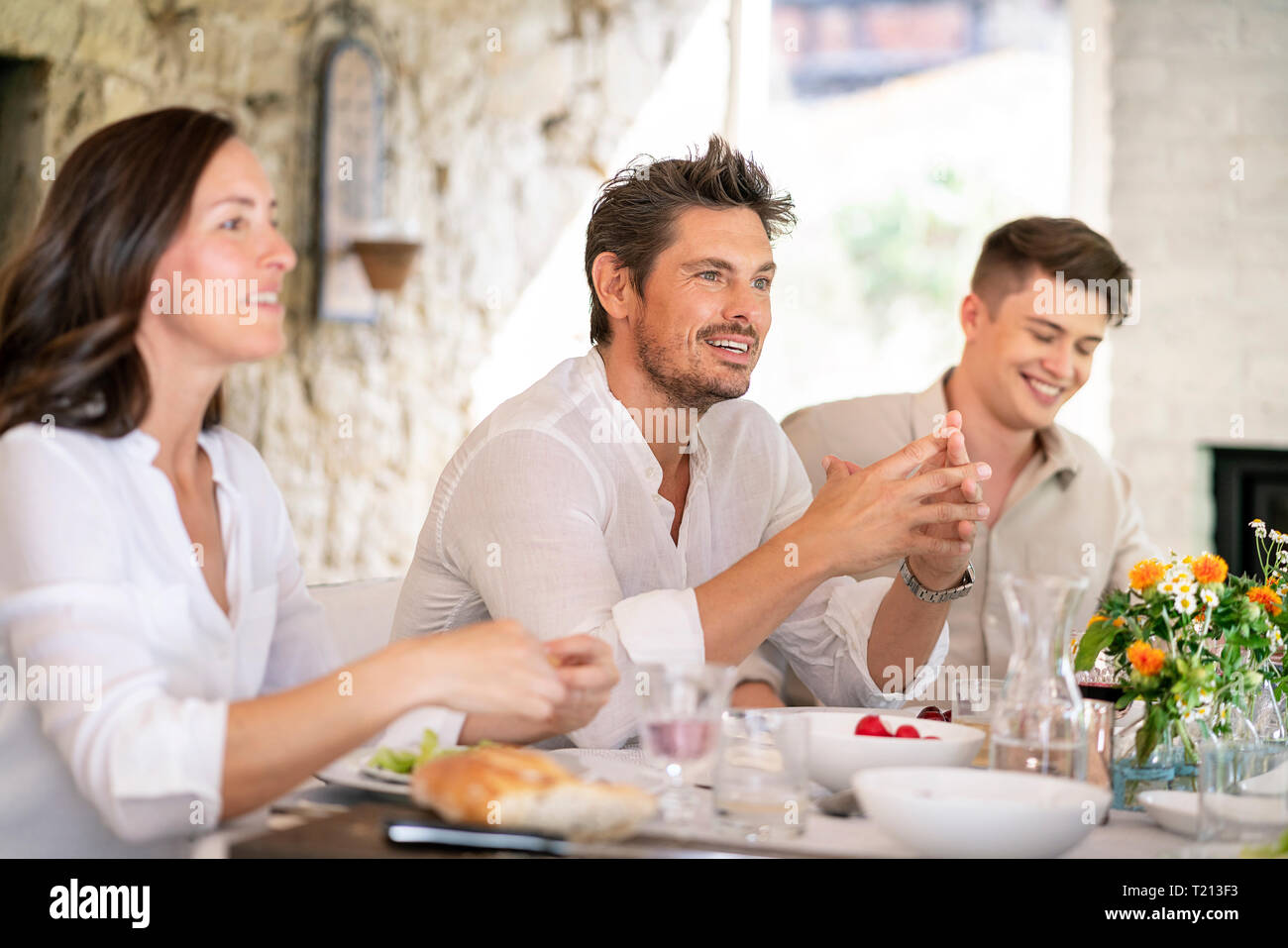 Happy family having meal together Stock Photo