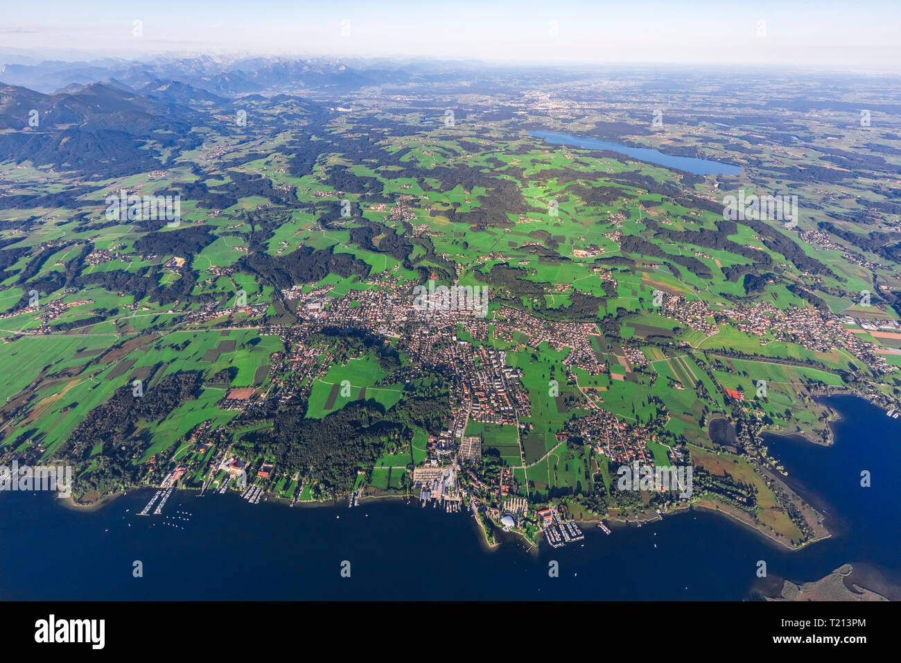 Germany, Bavaria, Aerial view of Lake Chiemsee, Prien, Rimsting and Schafwaschener Winkel in the foreground. Rosenheim and Simsee in the background Stock Photo