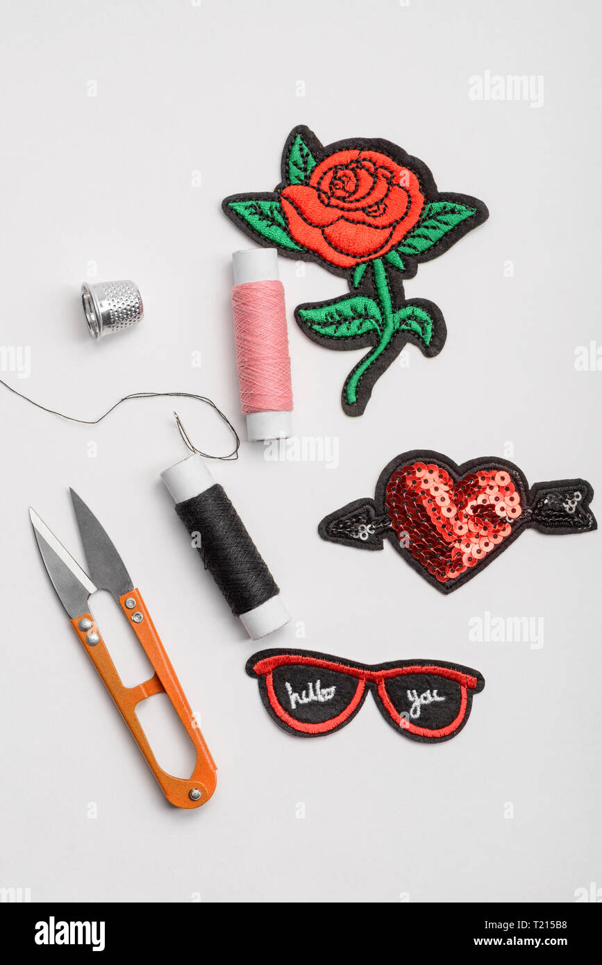 Patches, scissors, thread and thimble Stock Photo