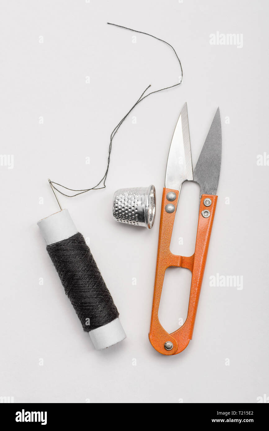 Black thread, thimble and scissors Stock Photo
