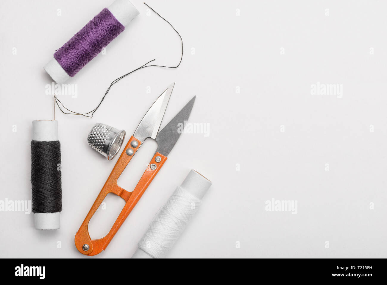 Thread, needle, thimble and scissors Stock Photo