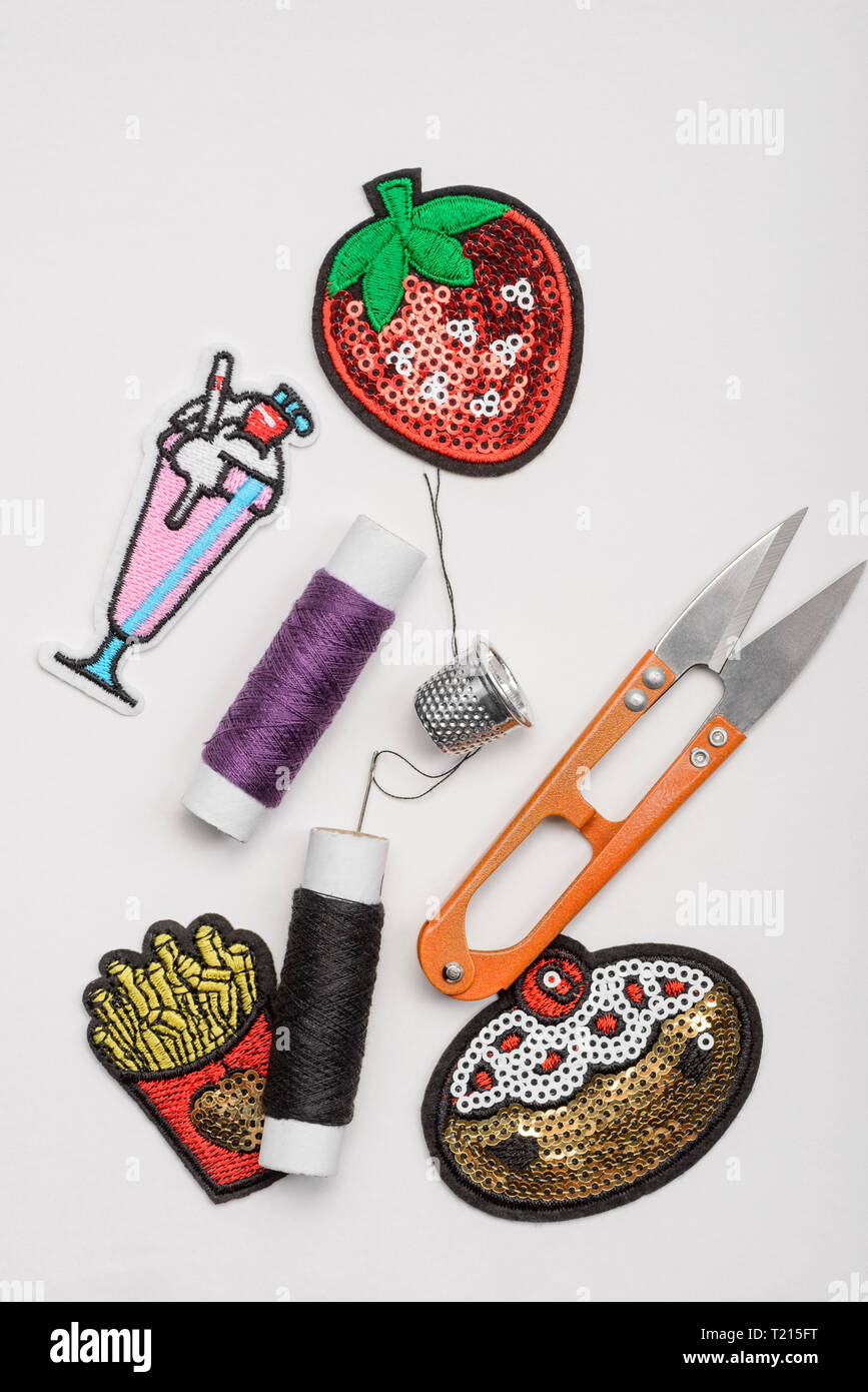 Thread, thimble, scissors and patches Stock Photo